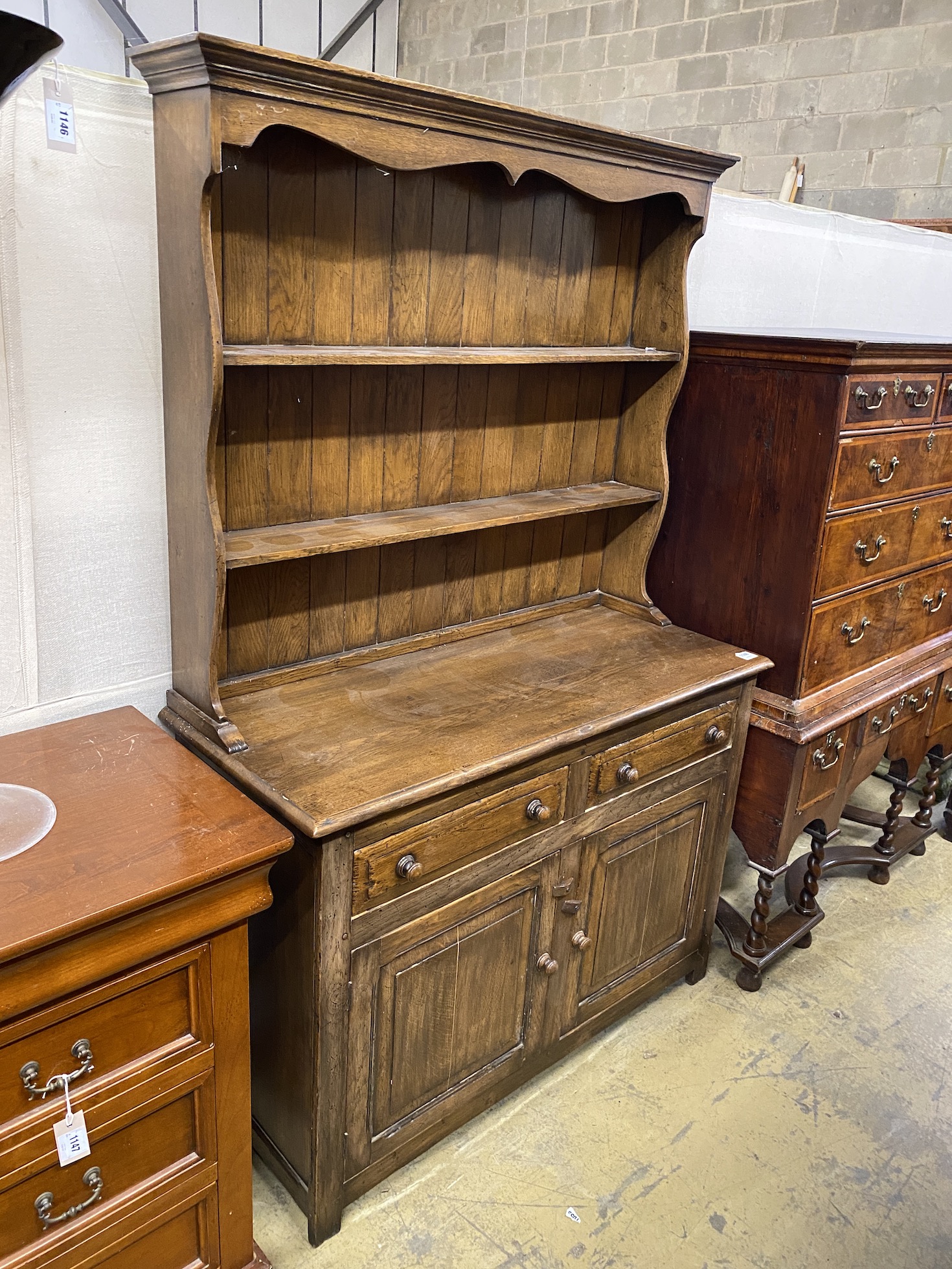An 18th century style oak dresser with boarded rack, length 117cm, width 48cm, height 182cm